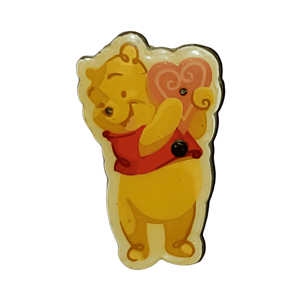 Winnie-the-Pooh holding a light up heart Disney pin